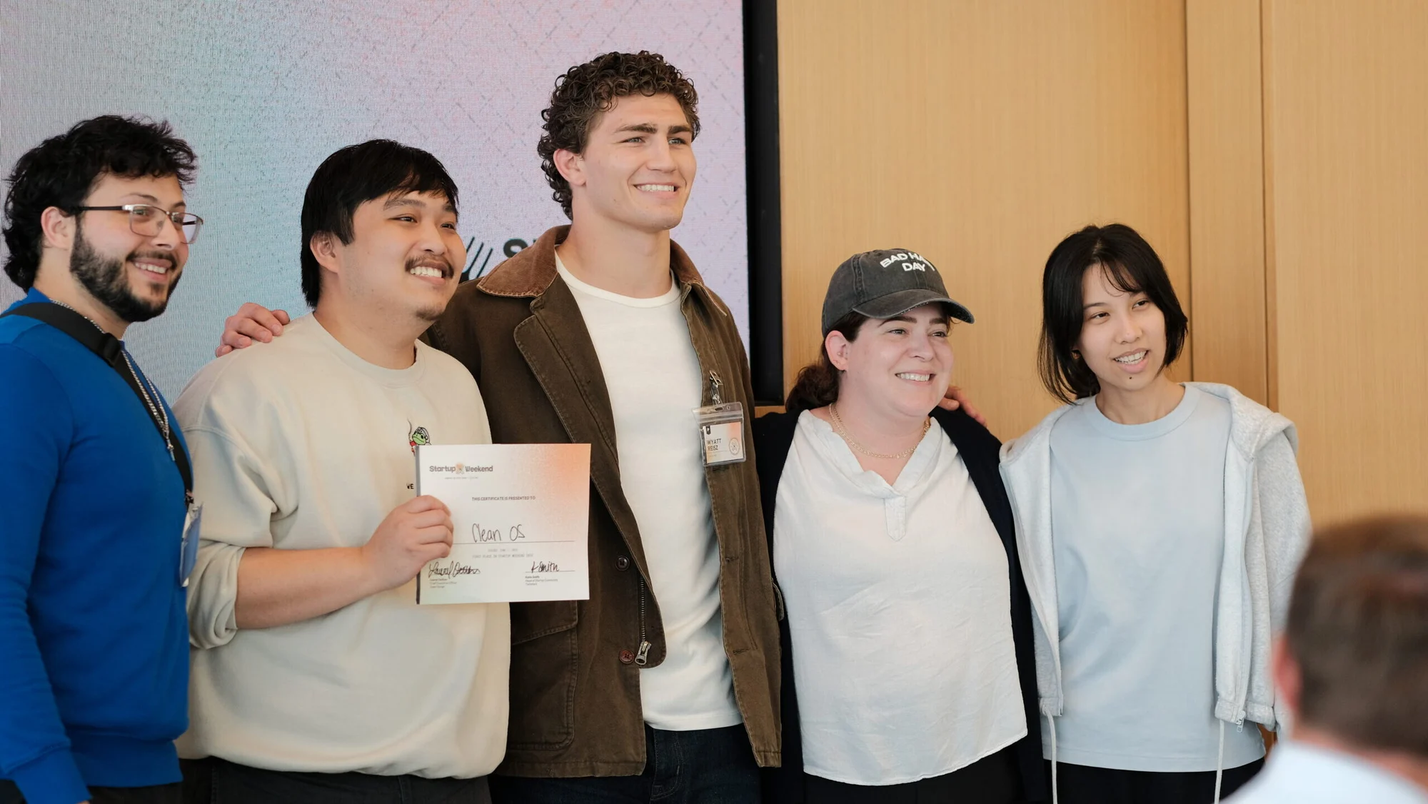 The CleanOS team holding the winning certificate